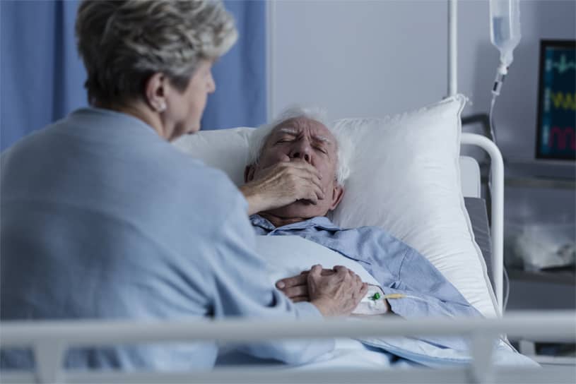 A wife with her husband in hospital who has mesothelioma
