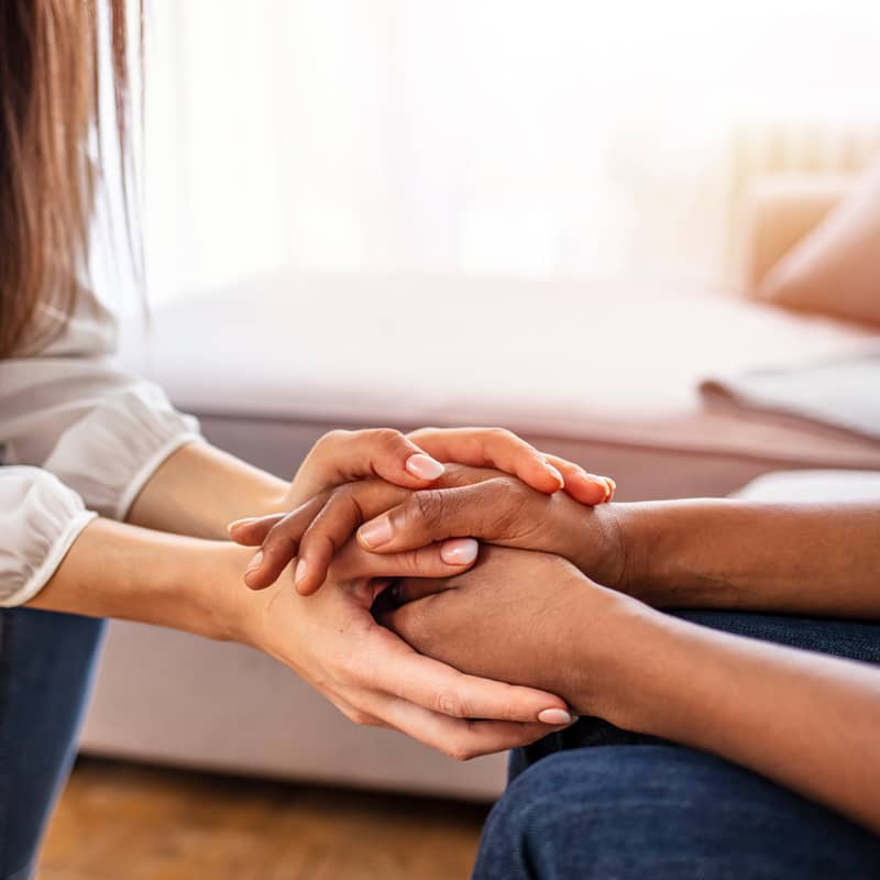 Person comforting another person.