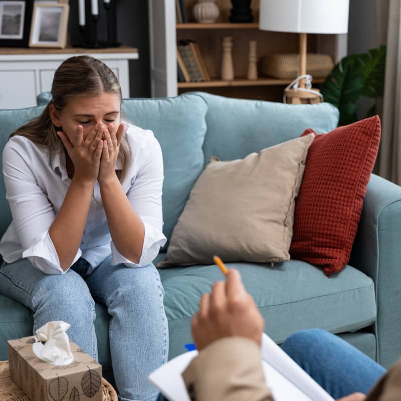 Emotional woman speaking to a counsellor.