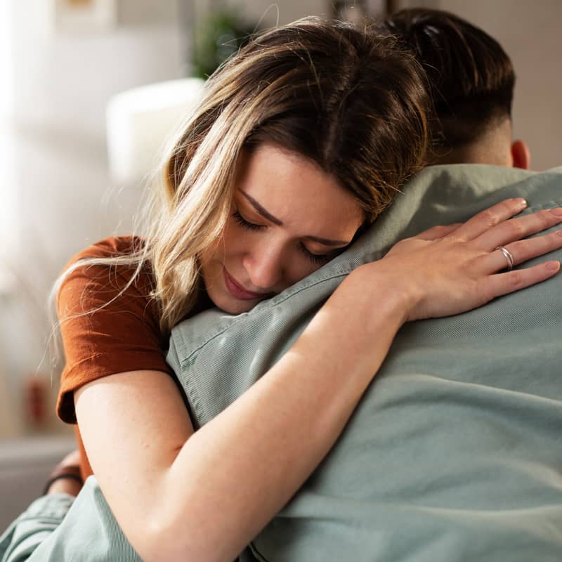 Woman comforting a man.
