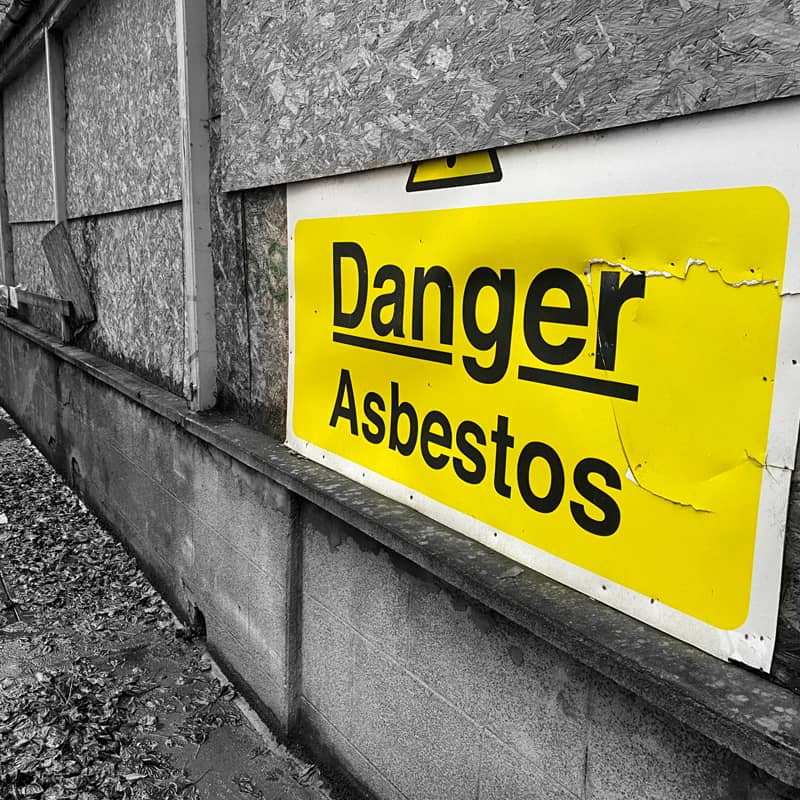 Sign warning of the danger of asbestos at a site.