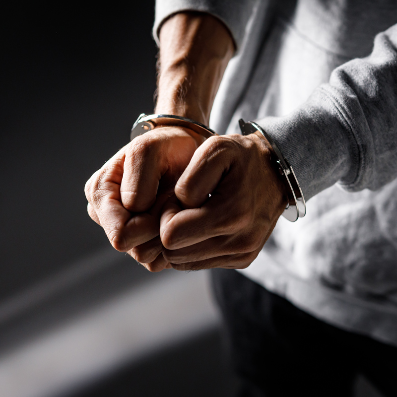 Person in handcuffs.