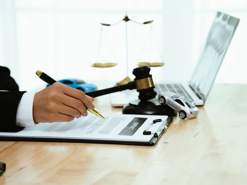 Solicitor filling out an important paperwork document.